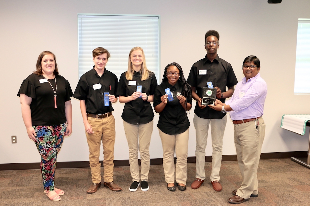 Terrell County's Georgia 4-H Food Product Development team won first place in this year's Food Product Development Contest with their take on kompot, a Slavic fruit drink. Georgia 4-H's Courtney Brown and Associate Professor Anand Mohan congratulates team members Sebastian Shattles, Hannah Grubbs, Janya Scott and Larry Hall.