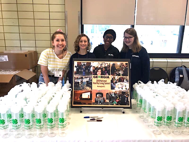 A group of Georgia 4-H members is using a grant from the Robert Wood Johnson Foundation and National 4-H Council to teach their fellow 4-H'ers to make healthier snack and beverage choices. The students are showing handing out water bottles at the Georgia 4-H Senior Conference in April.