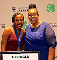 Georgia 4-H member Tandria Burke of Dougherty County was among the 4-H'ers who earned the title of Master 4-H'er during Georgia 4-H State Congress held July 23-26 in Atlanta. Burke competed in the Companion and Specialty Animals category. She is shown (left) with University of Georgia Cooperative Extension 4-H Agent for Dougherty County Jazmin Thomas.