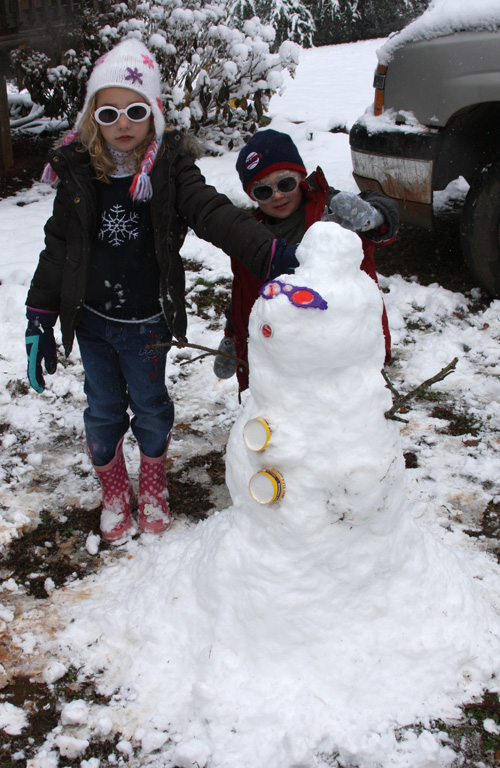 Two children build a snowman on Christmas Day 2010 in Nicholson, Ga.
