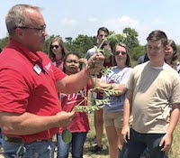 Students in the One Georgia program are shown learning about watermelon farming from Sumter County Extension Agent Bill Starr. While in south Georgia, the students also visited cotton fields and saw turfgrass sod harvested.