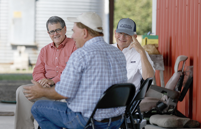 UGA President Jere W. Morehead and Georgia Commissioner of Agriculture Gary Black talk with Lee Cromley at Cromley Farms in Brooklet, Georgia.