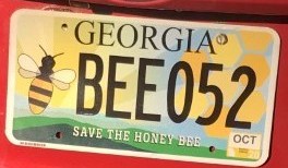 Jennifer Berry, an apiculture research professional and lab manager for the University of Georgia Honeybee Program, proudly displays her "Save the Honeybee" Georgia license plate. Thanks to the work of the Georgia Beekeepers Association Georgians can now buy the tag at the GBA website (gabeekeeping.com).