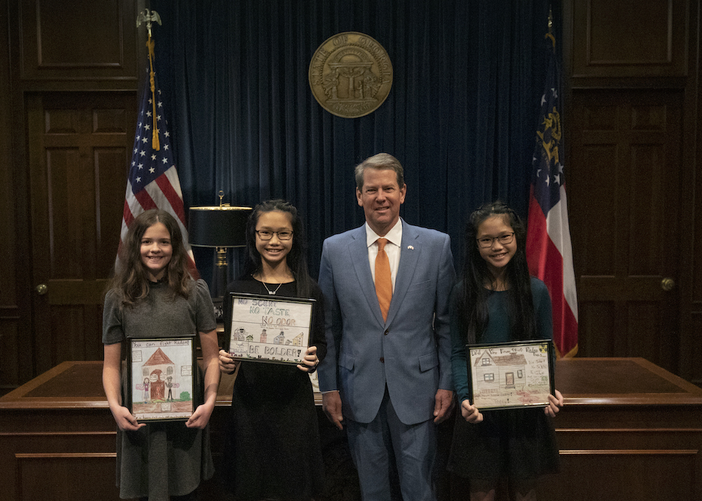 Fifth-graders, from left, Emi Hoang, Caitlin Smith and Gia Hoang, receive kudos from Gov. Brian Kemp on their Radon Awareness Posters. Gia Hoang won first place in the UGA Cooperative Extension Radon Awareness Poster Contest. Caitlin Smith and Emi Hoang, won second and third places respectively.