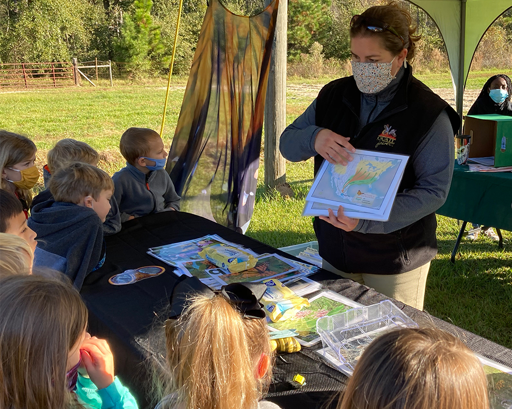 Jessica McGuire, with the nonprofit conservation organization Quail Forever, teaches students about wildlife conservation at Shiver Elementary School, where Grady County 4-H'ers planted a pollinator garden to help students understand the importance of protecting ecosystems.
