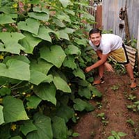 A 4S student from Reynaldo Salinas Institute in Honduras poses with produce he grew at home through the Honduras 4S From Home program.
