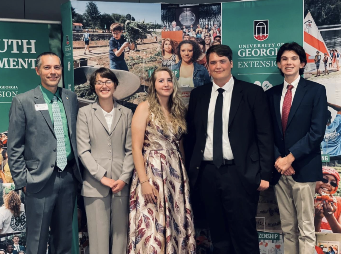 Coach Paul Pugliese (left) poses for a photo with the Bartow County 4-H forestry team, including Sasha Morgan, Bethany Craven, Gabriel Craven and Gus Federico.