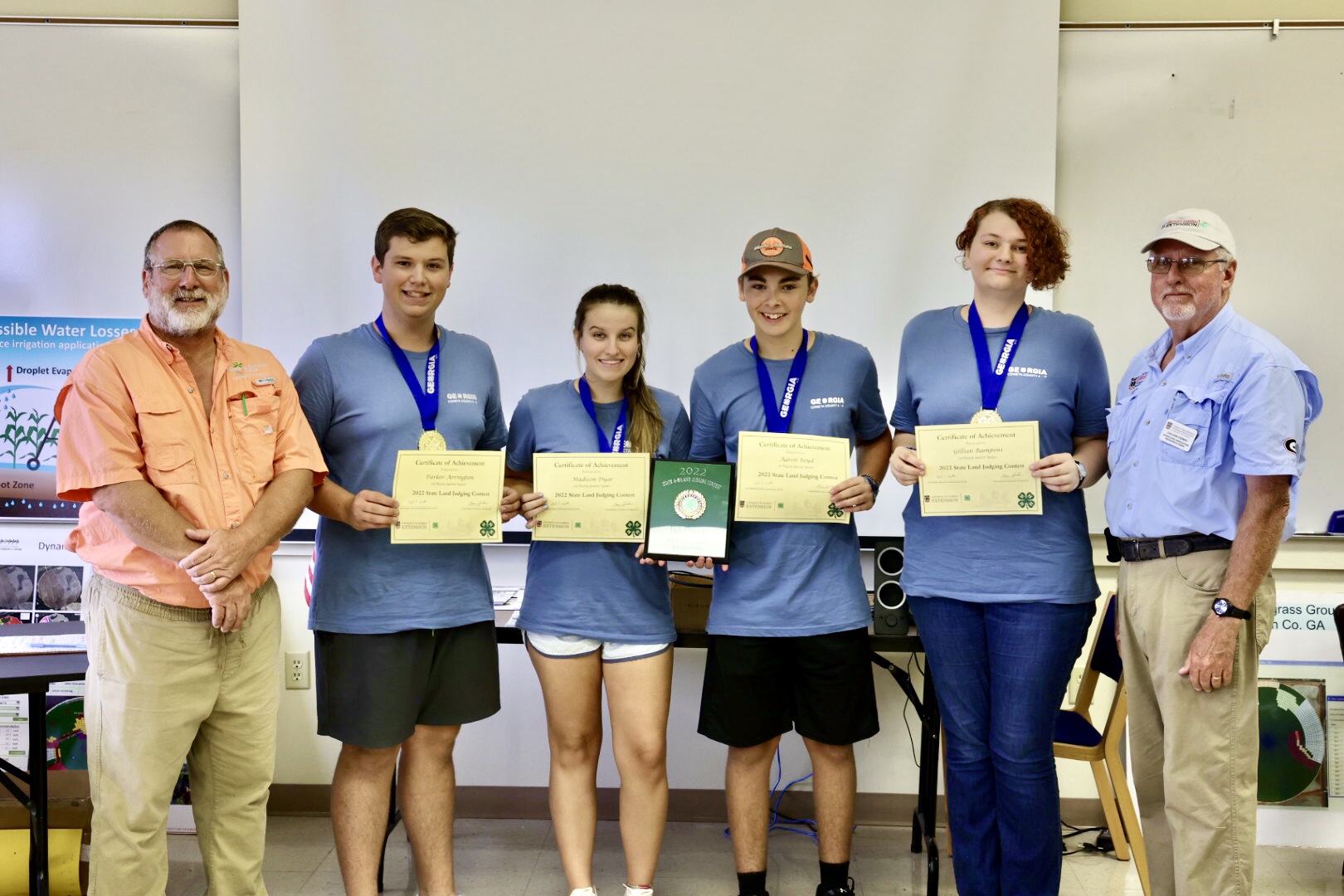 UGA Soil Scientist and judge Glen Harris congratulates the Coweta County Senior 4-H land-judging championship team, including (left to right) Parker Arrington, Madison Dyar, Aaron Boyd and Gillian Ramponi, with Stripling Research Park Superintendent Calvin Perry.