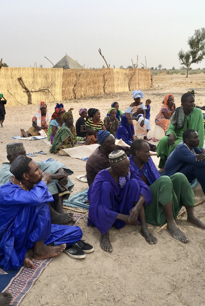 A group of farmers in Senegal receive survey instructions