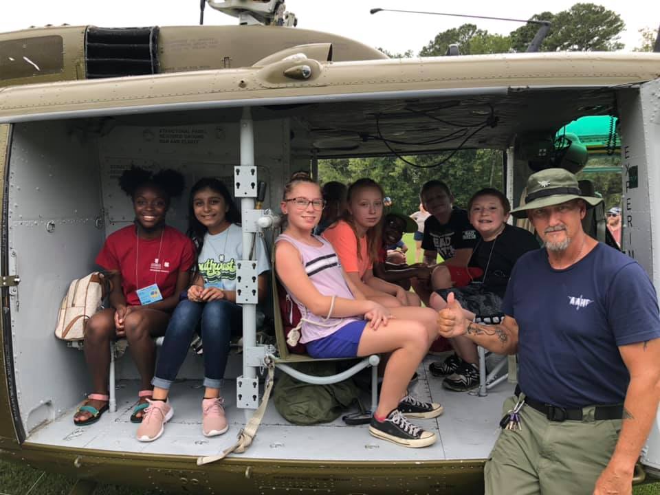 4-H'ers from Ben Hill County get a tour of a Vietnam War-era helicopter at the Mission Make-It event.