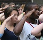 Campers at Teen Summit salute the American flag during the flag raising ceremony at Wahsega 4-H Center.