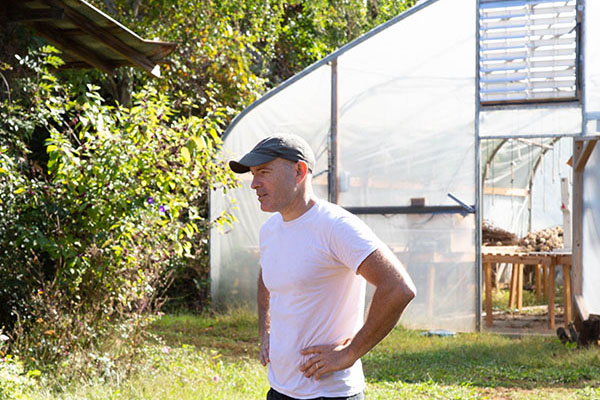 Steve O'Shea stands in front of a greenhouse on 3 Porch Farm.