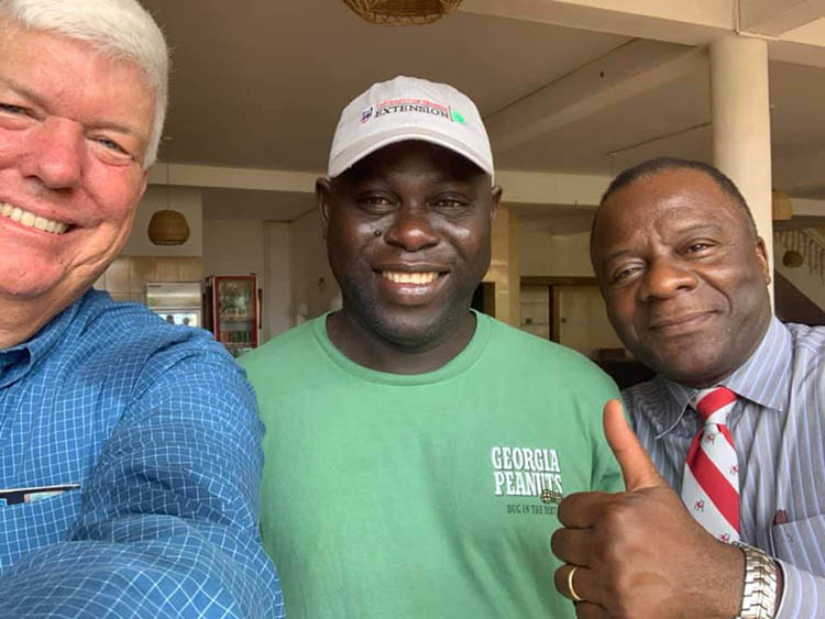 Kemerait (left) takes a photo with local host Basiru Barrow in The Gambia and UGA colleague Greg Fonsah.