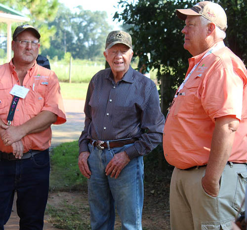Former President Former President Jimmy Carter (center) talks with UGA scientists Glen Harris (left) and Bob Kemerait during the Georgia Peanut Tour in 2017.