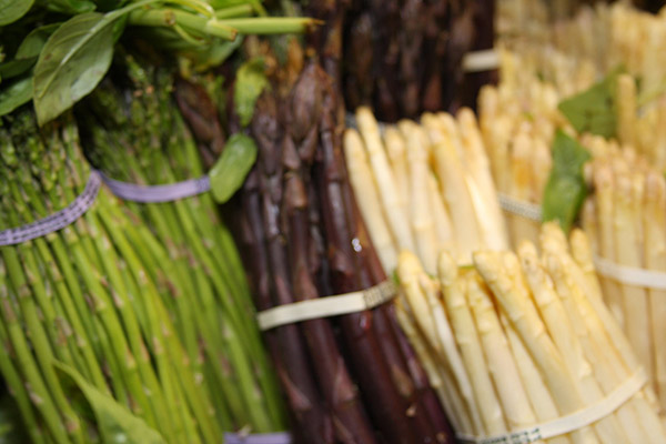 Bundles of different colored asparagus.