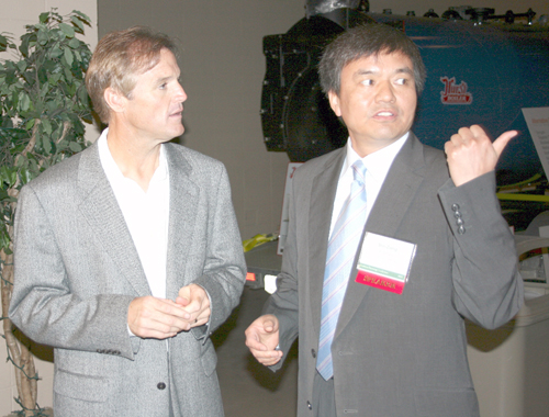 NASCAR Nationwide Series driver Kenny Wallace talks ethanol and alternative energy with Shi-Zong Li, deputy director of China's Tsinghua University Institute of New Energy Technology, at the 6th annual Southeast Bioenergy Conference Aug. 9 in Tifton, Ga.