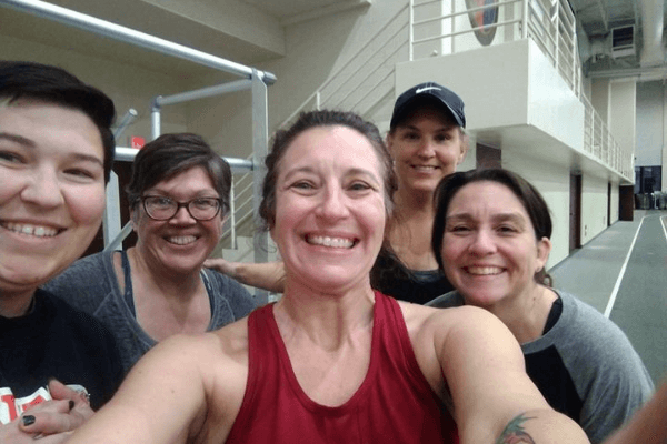 Selfie of five white women on an indoor track.