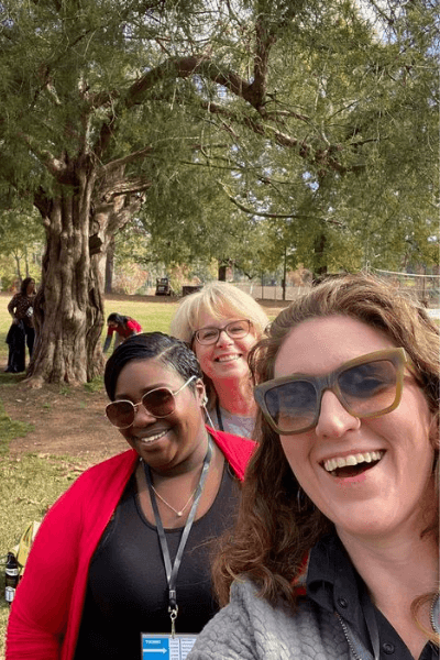 Selfie of three women outside in front of a large tree with Spanish moss.