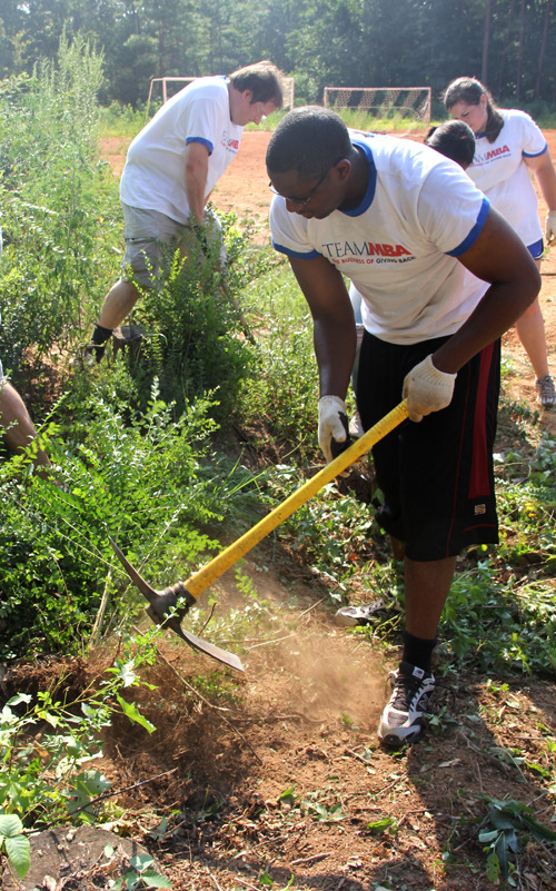 UGA MBA students chop down privet and other weedy shrubs at the Garnett Ridge Community Garden in Athens, Ga., on Aug. 9, 2011. MBA students start their first year off with a community service project.