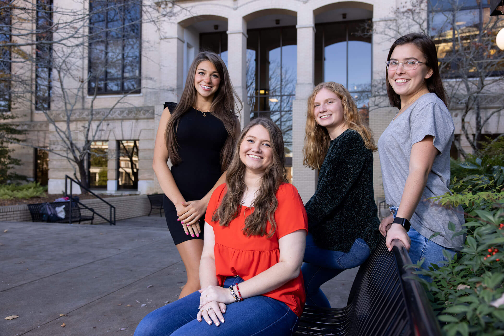 First cohort of Rural Scholars smile with arms interlocked on campus