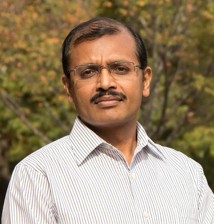 Sudhagar Mani in front of a background of trees