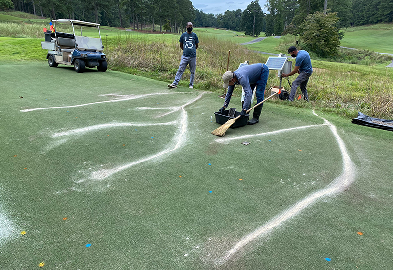 Mussie Habteselassie, (left) #### and #### install sensors in the soil on field test plots at the Rivermont Golf Club in Johns Creek, Georgia, to monitor oxygen, temperature and moisture. Rivermont course superintendent Mark Hoban agreed to work with UGA on the project in an industry-leading effort to transition into a golf course system that is more sustainable and less reliant on conventional inputs. 