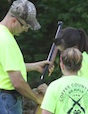 Brian Whitley, a certified rifle coach, is just one of the hundreds of volunteers that donate their time each year to the Georgia 4-H program. Whitley is shown competing in a coaches shoot with assistance from his daughter Danielle Whitley and Hannah Leggett.