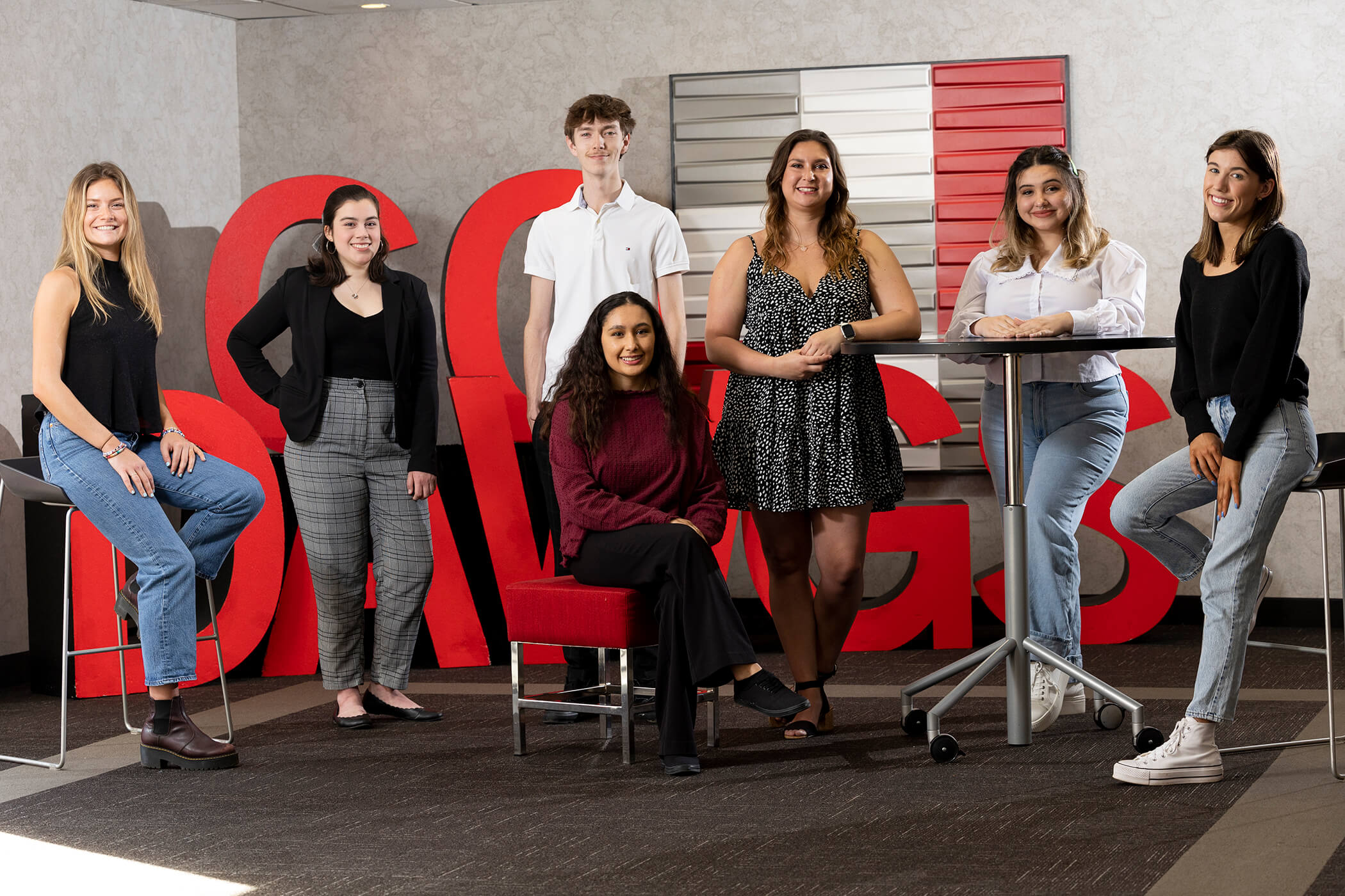 Hospitality and food industry management students Isabel Burr, Madison Cantrell, Morgan Carr, Liam Dennis, Natalie Ellison, Veronica Freeman, Breanna Raymond, Brianna Roberts, Morgan Schmidt and Ellie Strong, who will work the Masters, pose at the UGA Center for Continuing Education & Hotel in front of giant letters spelling "Go Dawgs."