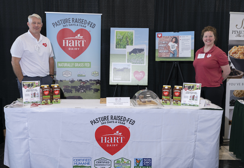 Richard Watson and Mandy Schulz pose in their booth for Hart Dairy