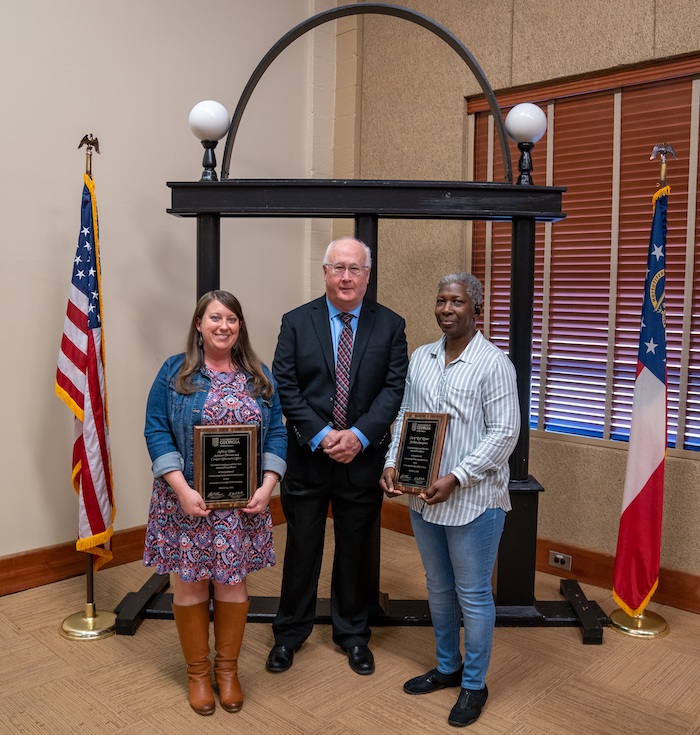 Ashley Biles and Clary "Ree" Rosser, the award winners, stand with David Buntin, the head of the Griffin campus