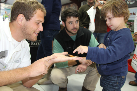 A young visitor to the UGA Pavilion at the 2011 Sunbelt Ag Expo in Moultrie, Ga., Oct. 19 learns about giant cockroaches.