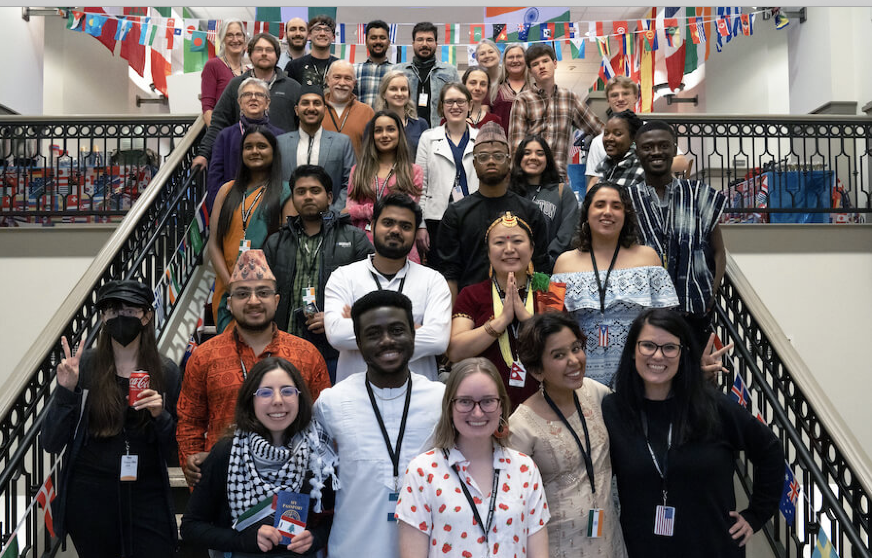 Students from the Taste of Nations pose together on a staircase