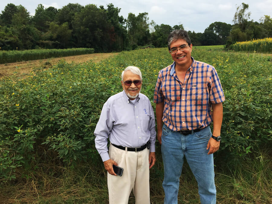 Horticulture Professor Juan Carlos Díaz-Pérez (right) stands in the field with friend and mentor Sharad Phatak.