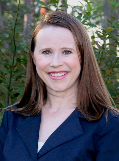 Amanda Smith smiling outdoors while wearing a blue blazer