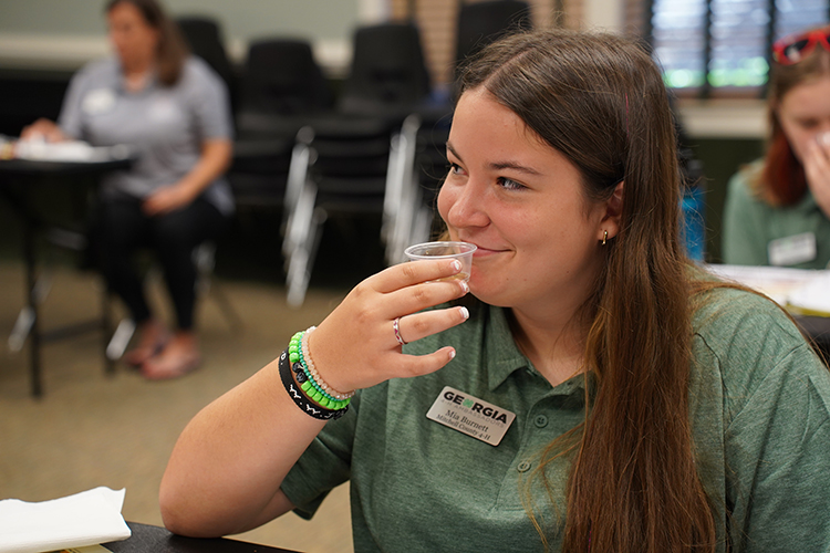 Mia Burnett, 4-H Ambassador for pollinators, tests a honey sample during training at Rock Eagle 4-H center in June. Burnett is one of 62 high-school students chosen for the 2022-23 Georgia 4-H Ambassador Program.