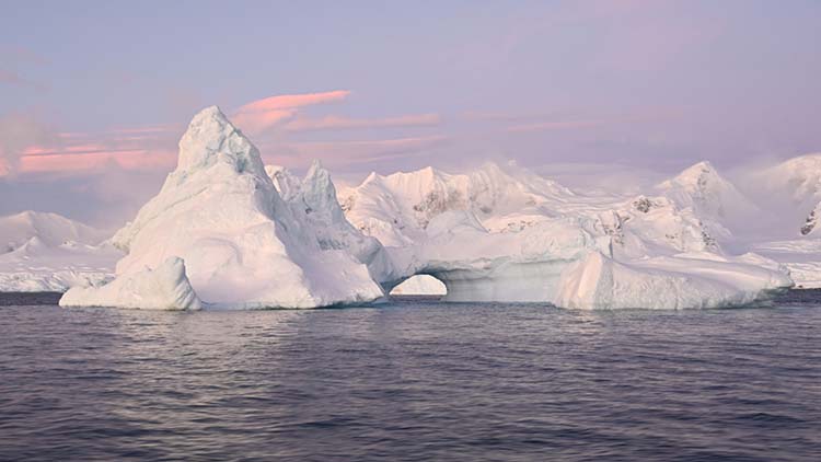 An arched iceberg along the Antarctic Peninsula, taken June 17, 2022. Last month Antarctic sea ice extent reached a record low for June, at 4.68 million square miles — or about 471,000 square miles below average. (Dan Costa/National Science Foundation/Creative Commons: https://creativecommons.org/licenses/by-nc-nd/4.0/)