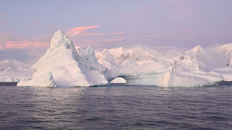 An arched iceberg located along the Antarctic Peninsula, taken June 17. Last month Antarctic sea ice extent reached a record low for June, at 4.68 million square miles — or about 471,000 square miles below average. (Photo by Dan Costa/National Science Foundation/Creative Commons)