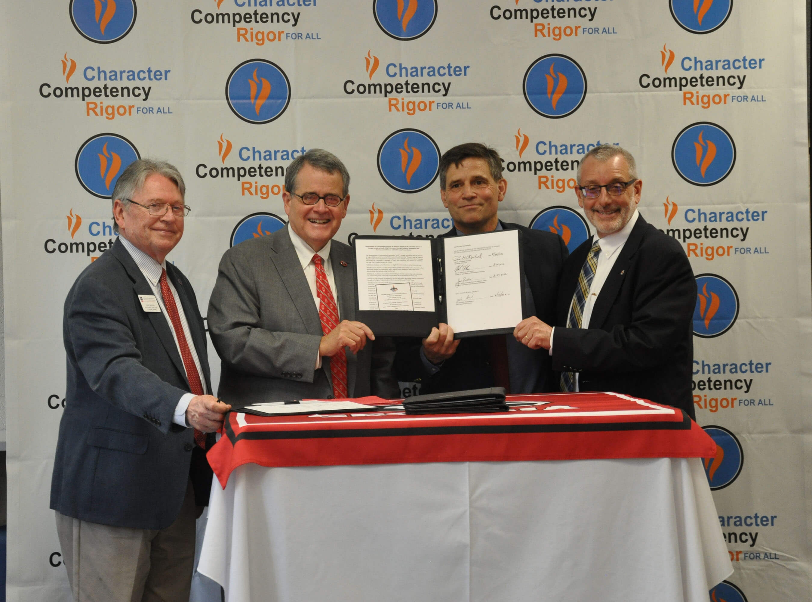 CAES Associate Dean for Instruction Josef Broder, UGA President Jere Morehead, Hall COunty Superintendent Will Schofield and CAES Nick Place celebrate the signing of the Ivester Rising Scholars Program on Aug. 29. 