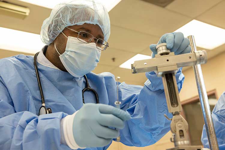 Professor Franklin West sets up the stereotaxic injector in the animal surgery suite of the Edgar Rhodes Center for Animal and Dairy Science.