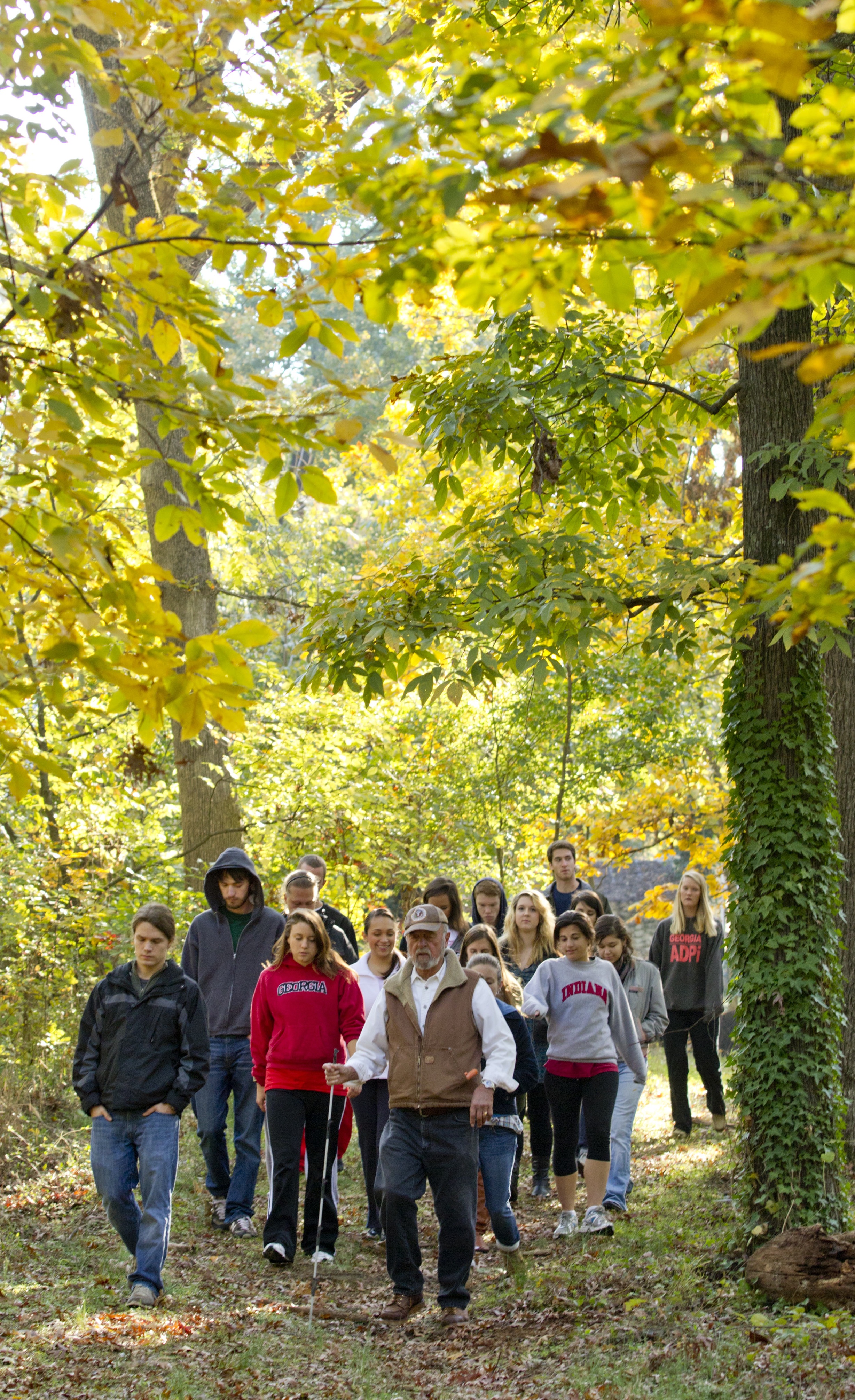 UGA senior research scientist emertitus Carl Jodan leads students on a walking tour of his farm.