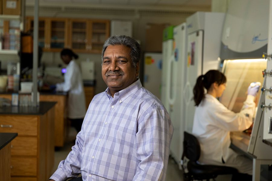 Portrait of Professor Harsha Thippareddi with graduate students working in the background in his lab.