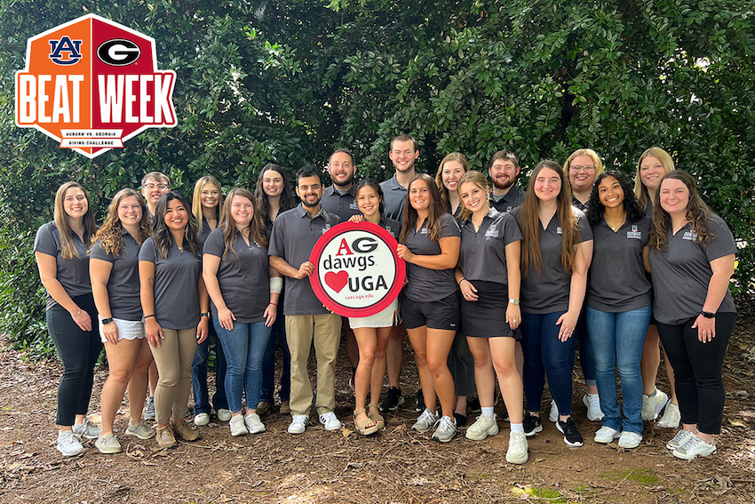 Members of the CAES Student Philanthropy Council gather outdoors with an "Ag Dawgs love (heart) UGA" sign. 