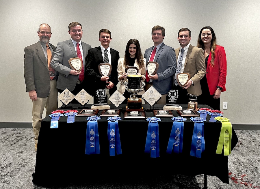 Team members from the Meat Dawgs hold awards from this season.