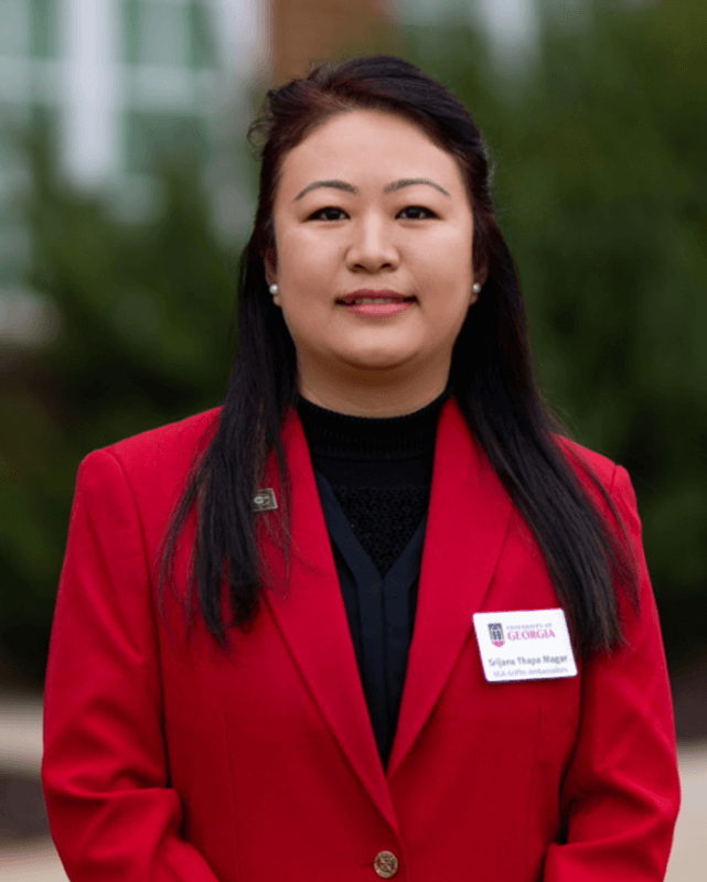 Srijana Thapa Magar wears the red blazer of a UGA-Griffin Student Ambassador