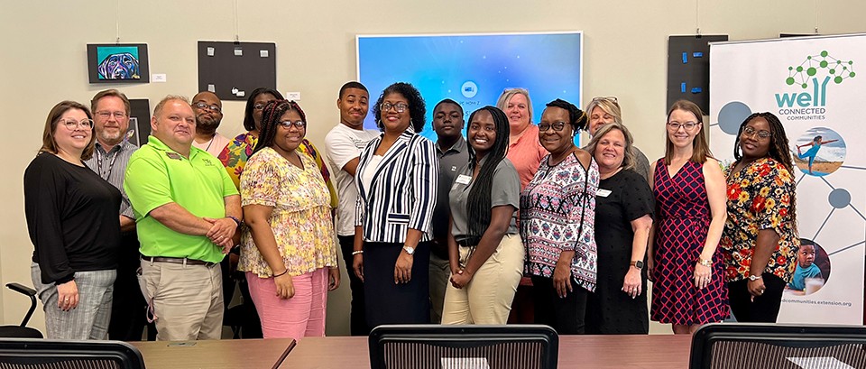 The Washington County Extension office hosts the 2022 Well Connected Communities Master Volunteer Academy Graduation. Participants gather in a conference room setting during the ceremony.