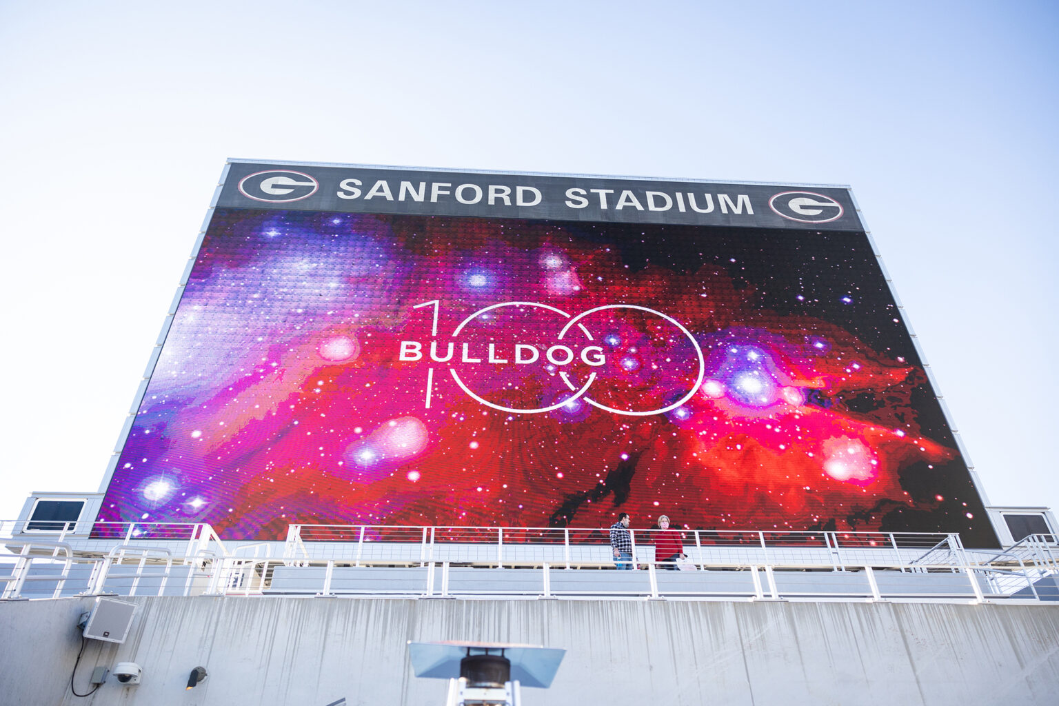 A jumbotron at Sanford Stadium displays the Bulldog 100 promotional mark