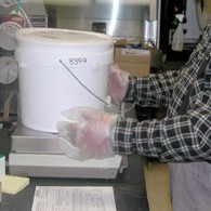 John Melin collects rain, sleet and snow samples for submission to the National Atmospheric Deposition Program. Melin is shown measuring and analyzing a sample.