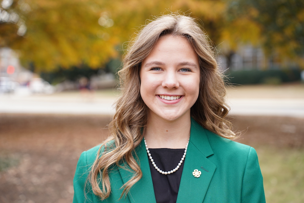 Hannah Jones smiles in a headshot while wearing a green 4-H blazer