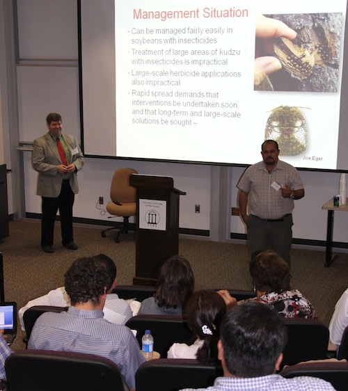 University of Georgia entomologist John Ruberson (left) discusses possible ways to control the kudzu bug. UGA interpreter Rolando Orellana was on hand to remove any language barriers.