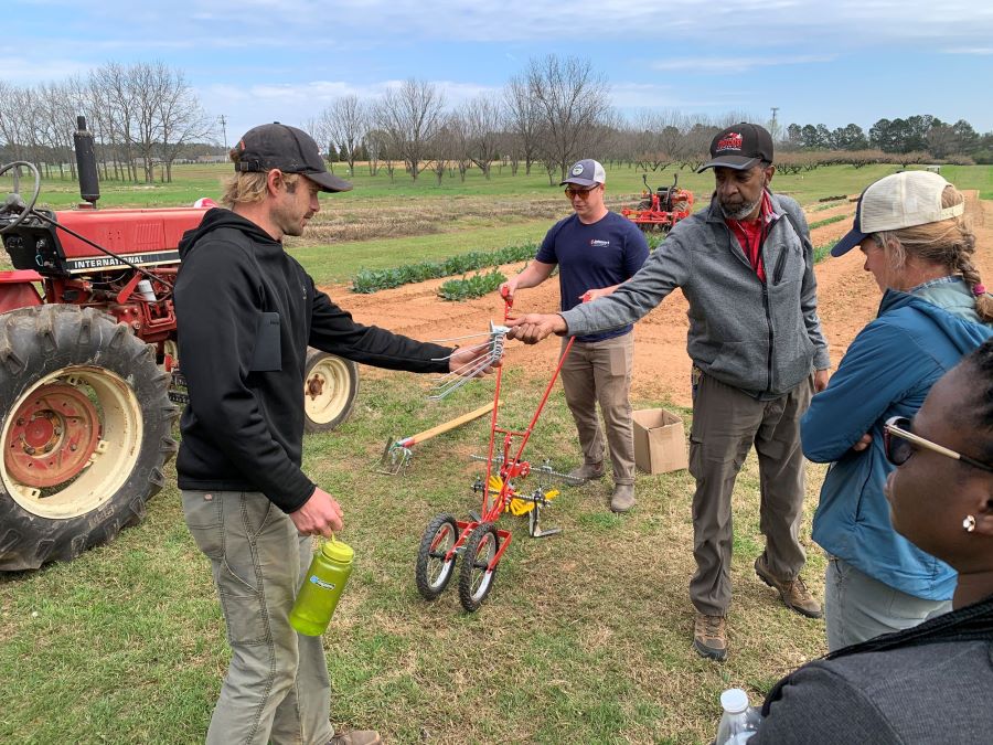 Organic growers learn how to use agricultural tools during the organic farmer field day at Durham Horticulture Farm.